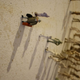 Illustration for article titled Mysterious, tiny human figures march across a wall